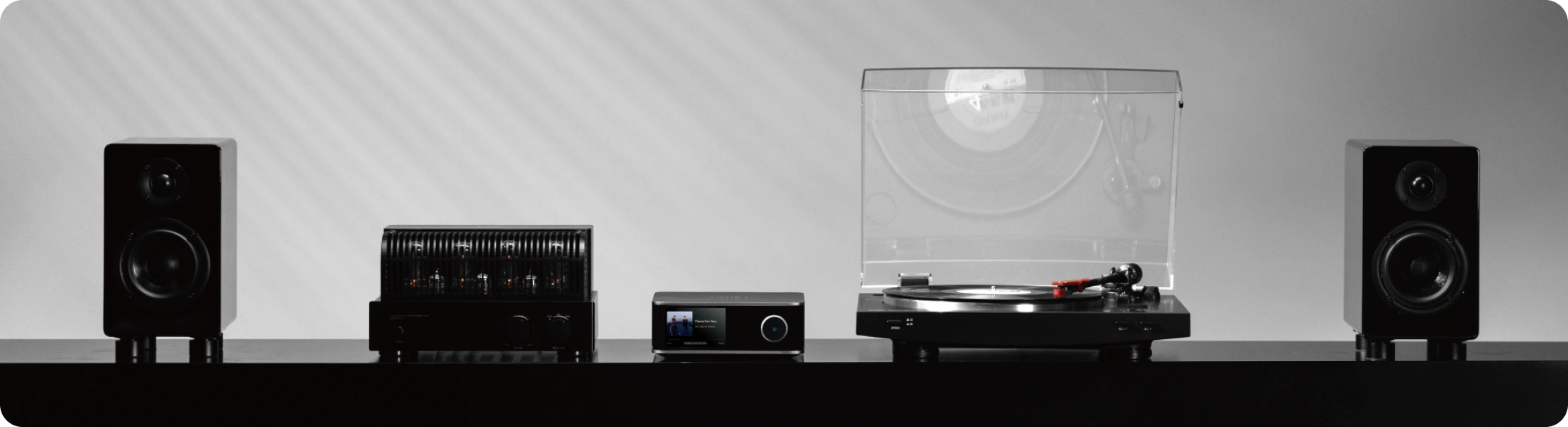 WiiM Ultra in a hi-fi system with an amplifier, turntable and bookshelf speakers